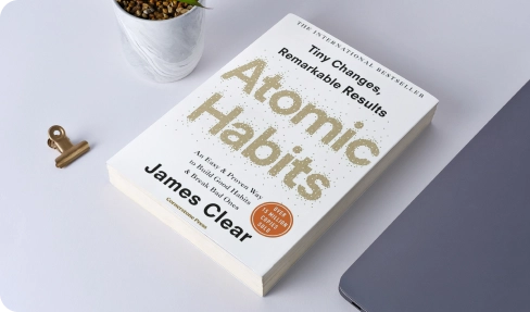 Atomic Habits book cover highlighting building good habits for organisations